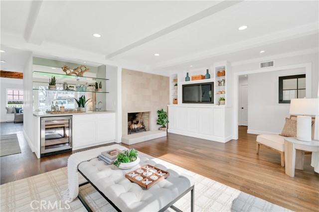 Living Room with wood burning fireplace and wet bar perfect for entertaining