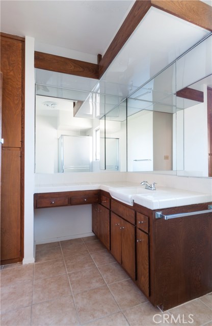 3/4 master bathroom has tile floors and updated tile vanity.