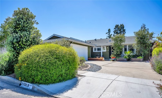 Nicely landscaped  front yard with inviting deck.