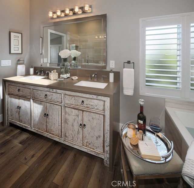 Primary bath including dual vanities and custom cabinets.