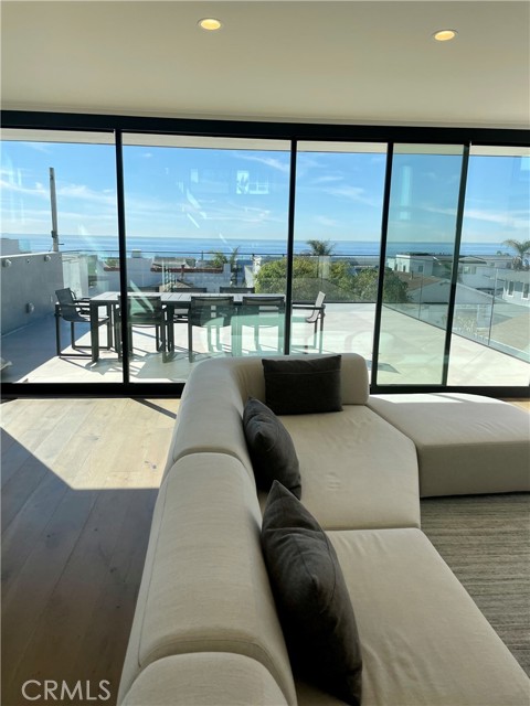 Living room looking out towards west facing deck. Remote control shades.