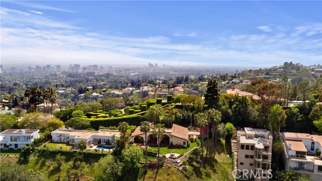 1328 Davies Drive Beverly Hills, California VIEWS, VIEWS and more VIEWS!!! Impeccably maintained Spanish architecture single story home on 1.31 ac with magnificent views of downtown and of multi million dollar estates. Also the garden is a piece of art with blooming spring and summer flowers, palm trees, fruit trees and many special specimens. Private pedestrian security gate and motor court gates plus fully fenced all around the property. 3 bedrooms, 2.5 baths, large great-room with fire place, wet bar with display cabinets and two large French doors open to back yard with large patio and BBQ counter. Formal dining room with plantation shutters and display shelves. State of the art appliances in the remodeled kitchen with new cabinets with auto close drawers top of the line cabinets with tongue and grove drawers. Wolf and Sub-zero appliances, granite counters and super nice black plash in an interesting pattern. Nook with garden window, built in bench and French door to lush garden. Laundry room with sink and storage. Master bedroom with French doors, two large closets, master bath-room with both a shower and a tub. Two secondary bedrooms with Jack and Jill bath-room. Large powder-room with granite floors. Wooden floor through the home accept accept the bathrooms. 2 car garage one door, Apoxy floors, insulated ceiling and built-in storage with pull down lather. This property is light and bright and it will sell fast so hurry to come and see it! The street is very desirable with many super expensive special properties just like this one, plus this property is one of the biggest lots. Video, drone and Matterport doll house plus floor plans are in the attachment sections. Please call if you cannot access them? A 10 page booklet brochure can be emailed to you. Easy to show just call or text listing agent.