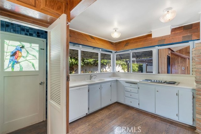 Kitchen counter looking out backdoor & windows