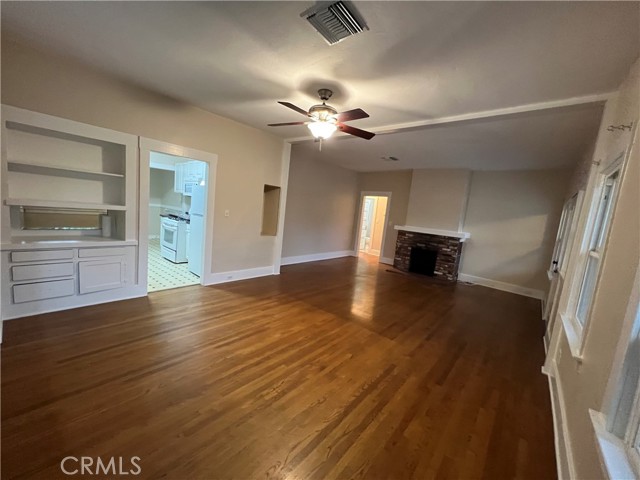 Dining area to fireplace and kitchen.