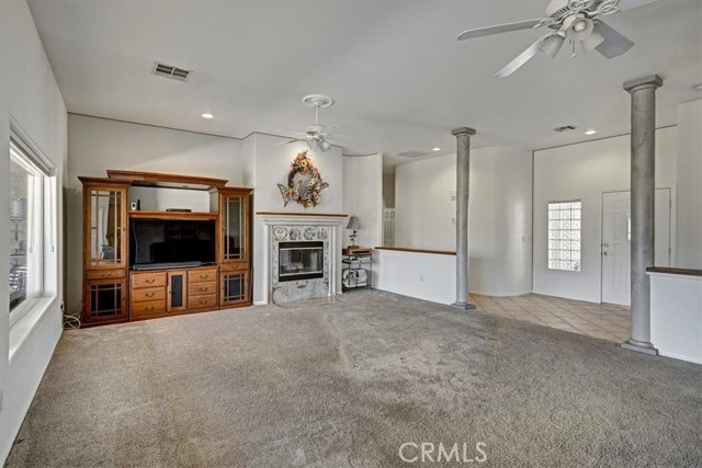 Open Family Room Featuring Fireplace and Entry.