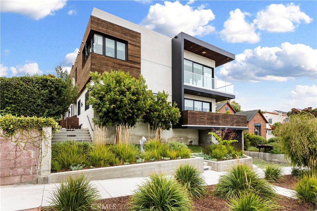 Welcome to the pinnacle of coastal living in South Redondo Beach, where luxury meets effortless modern style in this exceptional 6 year old townhome. Nestled within the prestigious “Avenues” neighborhood, this stunning residence offers the perfect blend of tranquility and vibrant beach living. With sweeping ocean views and a short stroll to the beach, award-winning schools, parks, and the charming shops and eateries of the Riviera Village, this home is truly about living your best life in Southern California. Step inside and be immediately captivated by the abundance of natural light, sightlines to the outdoors, fine architectural details, wide-plank oak floors and luxurious materials throughout. The expansive great room is a showstopper, with its breathtaking views of the ocean, Palos Verdes and an iconic series of beachside palm trees through dramatic 22’ Fleetwood multi-sliding doors. The open-concept layout and high ceilings add to the sense of volume, while architectural details like the sleek fireplace and custom wood display shelving add warmth and character. It’s an inviting space to gather with friends and family for both everyday living and sophisticated entertaining. The chef’s kitchen is a masterclass in both form and function, featuring a large statement island with seating for 5, quartz countertops with a waterfall edge, Viking appliances, wine fridge and a walk-in pantry. Whether you’re preparing a casual meal or hosting a dinner party, this kitchen has everything you need. The middle floor is home to the primary suite, where high ceilings and an adjacent balcony create a serene retreat. The spa-like bathroom features subtle stone and tile, a freestanding tub, large shower, double vanity, and custom linen cabinets. 2 additional bedrooms and a convenient bonus area, perfect for a home office or study space, are also on this level, offering ample space for family or guests. The lower level boasts a 4th bedroom or additional home office, along with a laundry room and direct garage access. 
Topping it all off is the grand roof deck, where panoramic ocean views and unforgettable sunsets await. Enjoy a quiet evening or host a lively gathering here. It’s yet another space designed for stylish outdoor living. With its unbeatable location, stunning design, high-end finishes, young age, & flat screen tv’s, this townhome is move-in ready & embodies the very best of beachside living. It’s easy to make every day feel like a vacation!