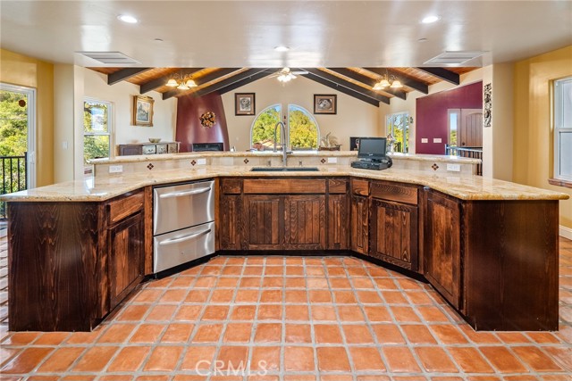 Living areas create an effortless flow that is ideal for hosting guests.  The kitchen island has a double drawer dishwasher and granite countertops.