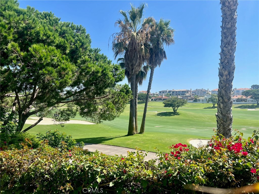 Experience the ultimate in Coastal Living from this single level condominium located in The Tennis Villas of luxurious Monarch Beach. Privately located within a gated community offering a community pool and spa, this rare find is your ticket to a life of ease, elegance and endless recreation. Overlooking the 16th Fairway of The Links at Monarch Beach Golf Course and moments to the Waldorf Astoria, Ritz Carlton Resort and Salt Creek Beach. Panoramic golf course views are enjoyed from the Living and Dining Room as well as the Master Suite, with dual doors opening to a spacious patio, ideal for entertaining or quiet mornings.  Embrace the convenience and comfort of single level living with air conditioning and direct interior garage access. Volume ceilings elevate every room and Plantation shutters accent the natural lighting enjoyed by this end unit location that boasts a  spacious greenbelt separation from other units.   Plank floors and mirror accents add contemporary touches to this special property. The open kitchen opening to the living and dining area, offers ample storage and counter space.  The master suite is a luxurious retreat with panoramic views, dual closets and mirror accents. This is your opportunity to discover one of the most affordable properties in sought-after and prestigious Monarch Beach, where every day feels like a vacation.  Welcome Home!
