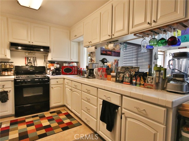 Another angle of the kitchen showing how many cabinet the kitchen has.