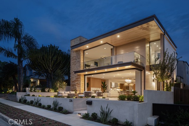 This stately residence, designed by renowned architect Mark Teale and crafted by premier builder JFB Custom Homes, showcases sophistication and refinement. Set on a rare 45' wide parcel in the esteemed neighborhood of Corona del Mar, just steps from the Pacific Ocean. This home offers approximately 4,560 sq ft of living space, enhanced by over 2,500 sq ft of sprawling terraces. Inspired by the natural beauty of the surrounding area and incorporating pocketing, floor-to-ceiling windows to invite in the natural light and create a seamless connection to the outdoors. The exterior is finished in premium reclaimed brick parfeuilles from the South of France and custom-colored marine-grade cedar. The main level of the home is spaciously designed, with a chef's kitchen equipped with top-of-the-line Miele appliances and a secondary prep kitchen, in close proximity to a built-in firepit and BBQ. The interior boasts warm oak floors and Italian large-format porcelain, enriching and enhancing the living spaces. The grand primary suite is a true oasis, complete with a blackened steel fireplace surround, private balcony, spa-like bathroom with a lavish 'Victoria + Albert' freestanding tub, dual closets, and separate water closets. The residence features 5 spacious bedroom suites with a ground-level bedroom suite, an upstairs bonus room, and an elevator servicing all 3 levels. The breathtaking landscape, designed by Chelsea Corinne Studio, perfectly complements the warm and architecturally captivating design of the home. The residence further features a 3-car garage, multiple water features, and solar panels. This new construction home, located on one of the most coveted streets in Corona del Mar, is a true masterpiece fit for the most discerning buyer.