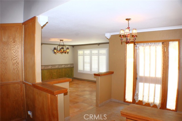 Formal Dining Room with Plantation Shutters and Tile Floors.