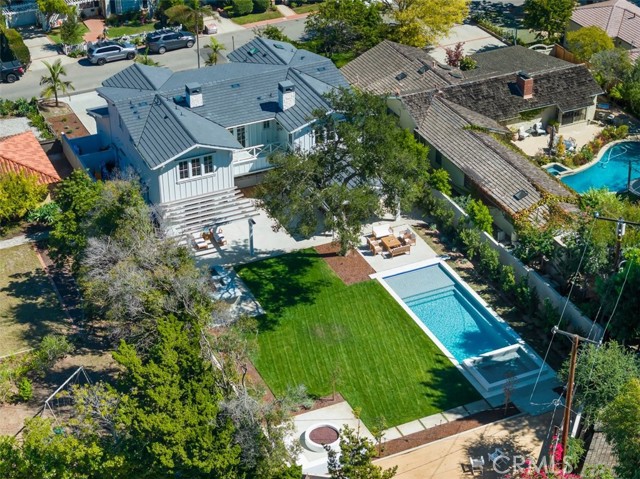 Backyard oasis with pool & spa, covered patio with fireplace, outdoor firepit, plus outdoor bbq/Kitchen