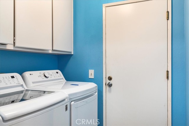 Indoor laundry with door to garage. Washer and dryer included.