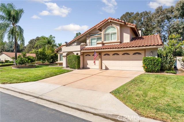 Beautiful home with pride of ownership. Balcony from Primary bedroom, three car garage and space to park three in the driveway. Tile roof. Citrus tree in front. Hibiscus plants by garage.