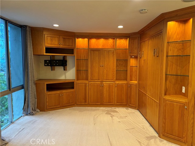 Beautiful living room cabinets that hide a Murphy bed!