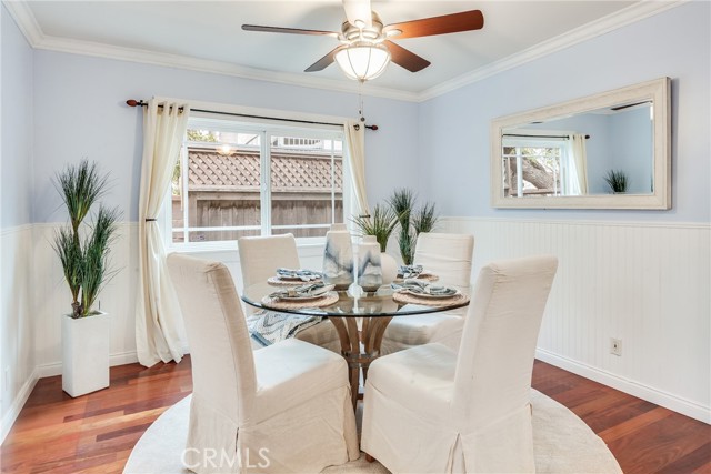 Newly painted dining room with wainscotting, hardwood floors and more