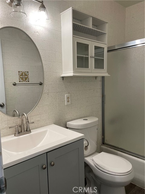 Full bathroom with new flooring, sink and toilet