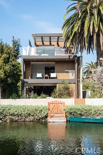 437 Howland Canal Venice, California Silicon Bay presents its newest project for the most discerning design, health and entertaining oriented buyers.
This warm modern rests on a sunny south facing lot on a very quiet, central location of the Venice Canals out of sight of the Dell bridge. Included in this 4 bedroom with en suite baths is a health center with cedar paneled walls, digitally controlled sauna, steam room, beverage center bar with adjacent exterior 5 seater stainless steel Diamond Spa. Full media room with tiered seating, and 3 outdoor entertaining patios and decks that your 4 stop elevator will take you to. Finishes include-Aluminum doors and windows-French White Oak Wood Flooring-Walnut Linea Paneled Cabinetry, Doors and Wall Paneling-Kitchen Island and Backsplash in Perla Venata Leatherize Nuage Quartzite, Master Bath Integrated Sink, Counters and Walls in Leatherized Nuage Quartzite, Indiana Buff Limestone Steam Room, Guest Baths wall stone, marble and porcelain-Electric Mirror Brand in Master Bath, Paris Backlit Powder Mirror, Backlit Mirrors-Stainless Steel Plumbing Fixtures by Graff, Hansgrohe, Axor, Victoria + Albert Eldon Master Tub, Franke -Kitchen Appliances are Miele Refrigerator and Freezer, Miele 48" Range, Miele 30” inch oven, 30 inch Miele Speed Oven with Microwave, 2 Miele Dishwashers, 2 Miele Full Height 30 inch Wine column Fridges-Spa Uline Beverage Center-Technology-Crestron Lighting System. If you’re looking to own the most incredible home ever offered on the canals, this is it.
