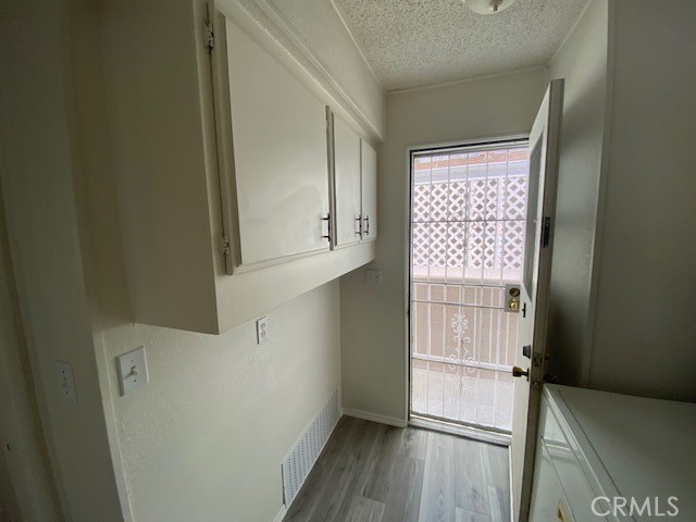 Laundry room with access to private/gated side yard and shed.