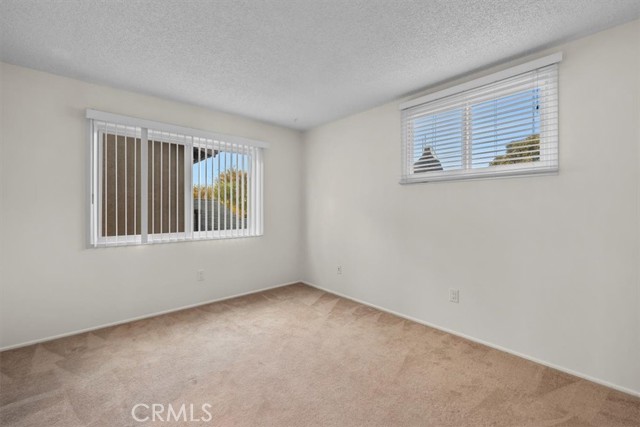 Bedroom #4. Left window faces West. Right window is North-facing.