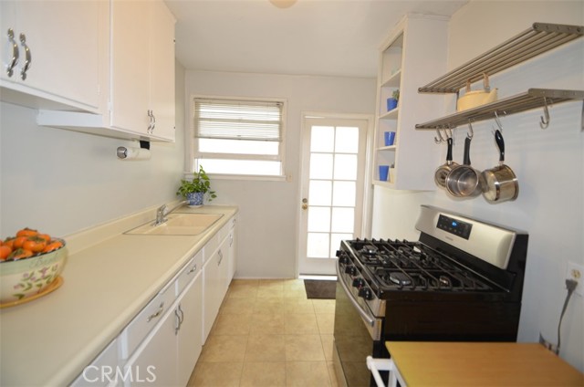 Off the dining room is a galley kitchen--tile floors, stainless 4 burner stove.