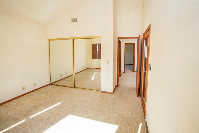 Bedroom #3: Vaulted ceiling and mirror closet doors