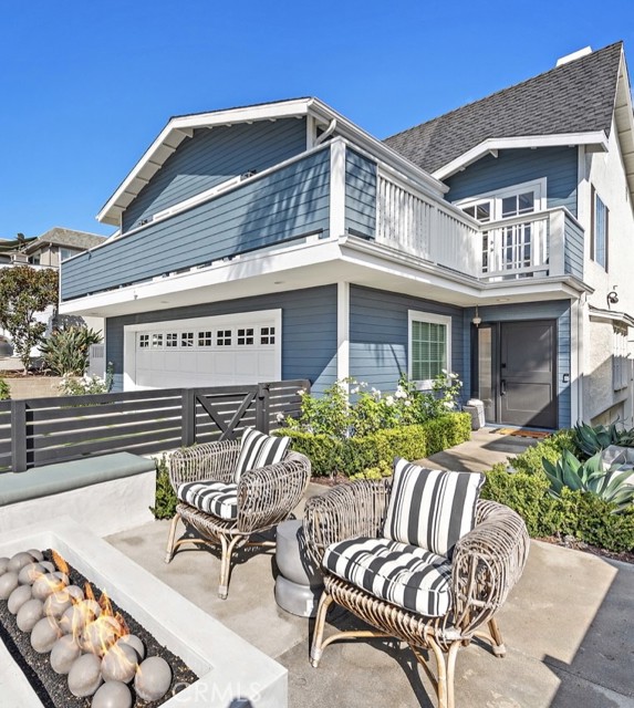 Cape Cod exterior with front courtyard with seating and fire pit