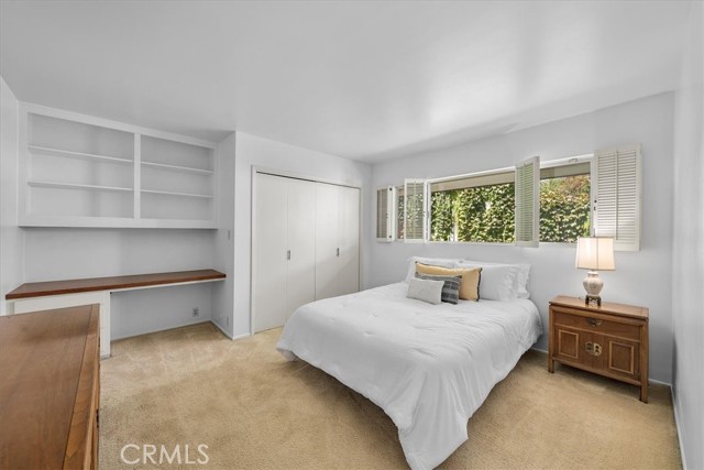 Second Bedroom with built in shelving and desk.