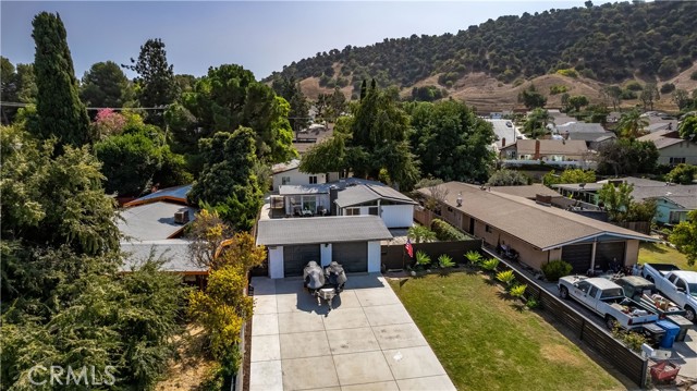 Aerial view of home facing 2 car garage with mountain views