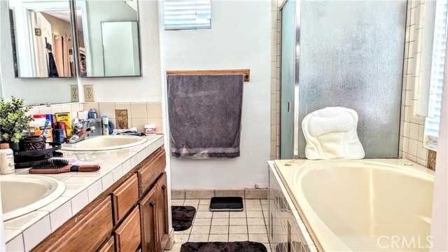 Main Bathroom with tub and show and Jack and Jill sinks