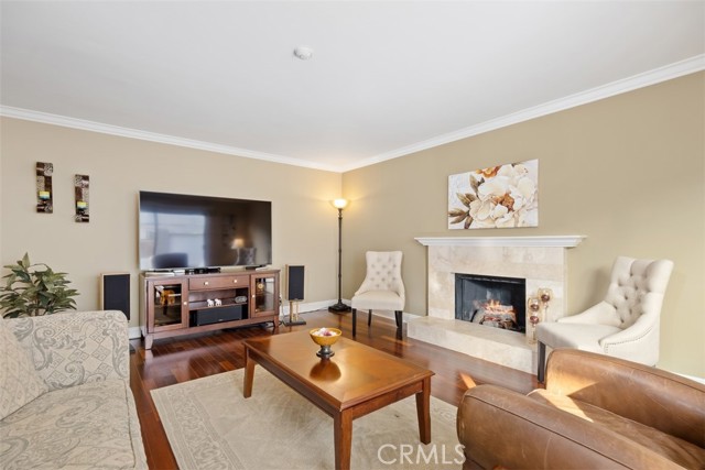 Beautiful wood flooring, cozy family room downstairs fireplace with sliding doors to the private backyard and patio