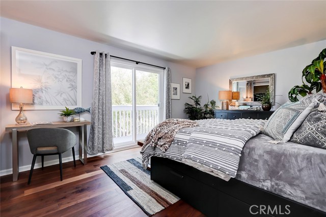 Peaceful guest bedroom with updated sliding glass doors leading to a private sunny southwest balcony.