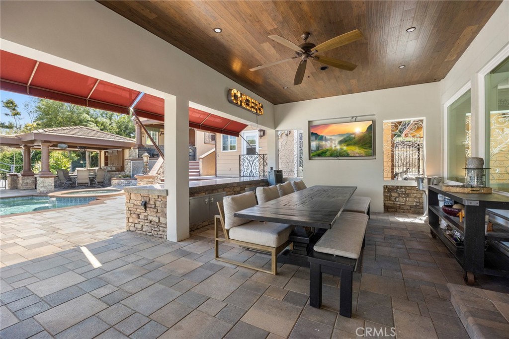 Large covered seating area with built-in storage and TV