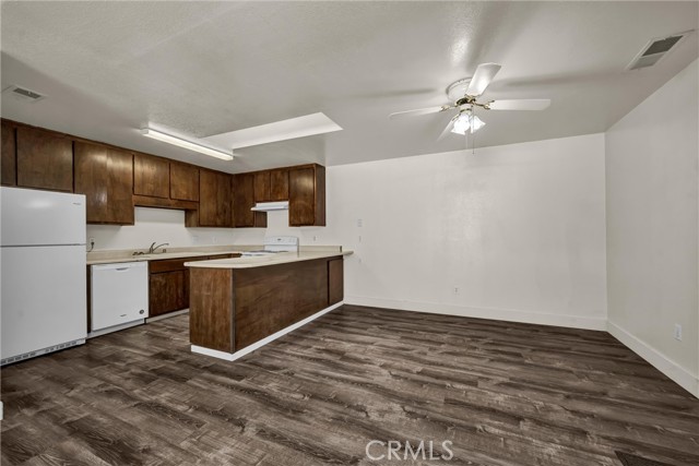 Kitchen includes fridge, dishwasher, range and hood.