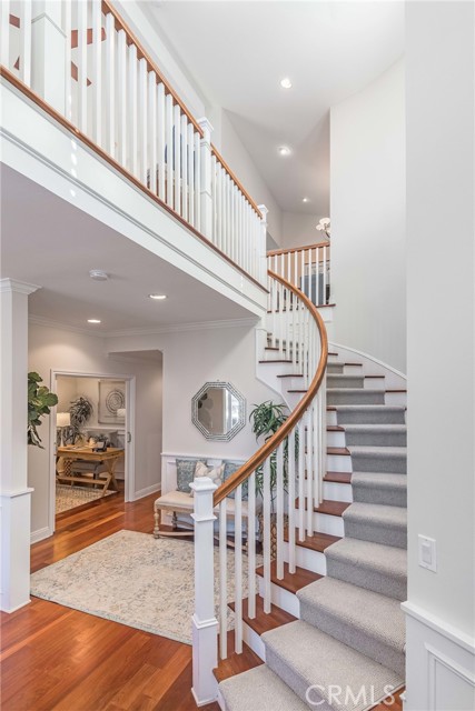 Beautiful curved staircase with gleaming hardwood and a elegant look....welcome home