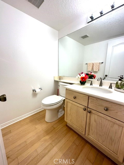 Convenient guest powder room by the stairway.