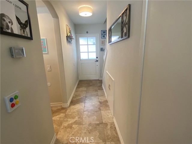 Hall to front door storage area under the stairs.