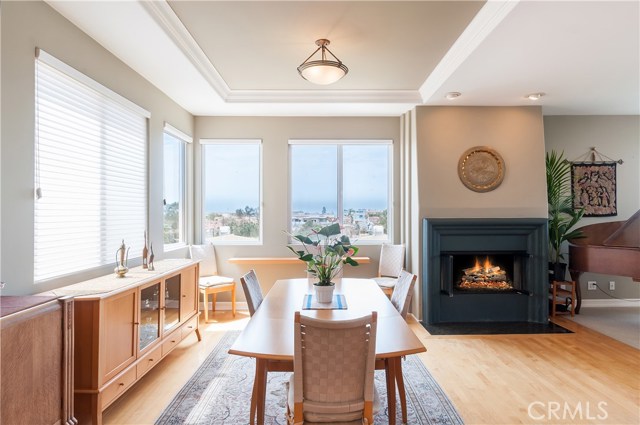 Ocean views are enjoyed from the kitchen and dining room, with a glowing fire to warm your mood!  Ceiling detail adds interest.