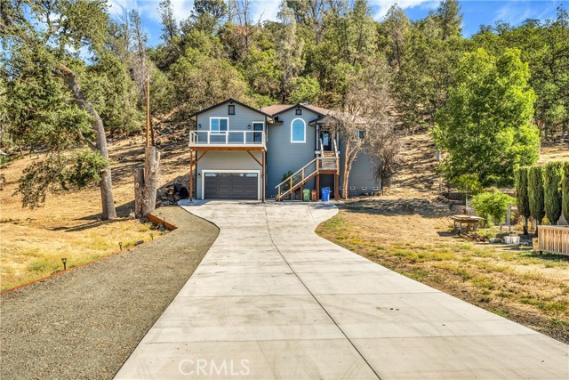 Nestled in the hillside with lovely valley views in the distance, this Nearly New 4 bed + den / 3 bath home has 2,679 SF & is situated on over 1/2 acre! Meander up the elongated driveway to a custom built home that is tucked in the trees and set back from the road for privacy. Built in 2020, this "spare no expense" home has it all! Head up the stairs to find a beautiful stacked stone entry which sets the tone. Enter to find a single level, spacious floorplan, that is open and airy! Tall ceilings, crown molding & recessed lighting can be found throughout. Living room with stylish laminate flooring & stacked stone, 42" heat circulating wood fireplace, with sensor. The upscale kitchen offers a modern flare with large kitchen island, granite countertops & coordinating backsplash. 6 burner, commercial style range + hood, beautiful tile and extra storage with large cabinet wall + pantry.  Dine & entertain at the kitchen island, breakfast nook or formal dining room with a view! Enjoy 4 spacious bedrooms + a bonus den or office. The primary suite offers coffered ceiling with crown molding and ceiling fan. Ensuite primary bathroom with eye catching tiled walk-in shower, dual sinks and large soaking tub. Walk-in closet for all of your storage needs! Enjoy being outdoors? Spend time star gazing on the expansive front deck or host friends on the expansive concrete patio out back. This home is solar & electric car ready and includes an upgraded 40 year roof, on-demand water heater and emergency power panel for power shut-off. Ideally located a short distance to stores, schools, coffee, pizza and the new Greenview Restaurant + Pro-Shop slated to open in fall 2022. This stunning Hidden Valley Lake home is one not to be missed!