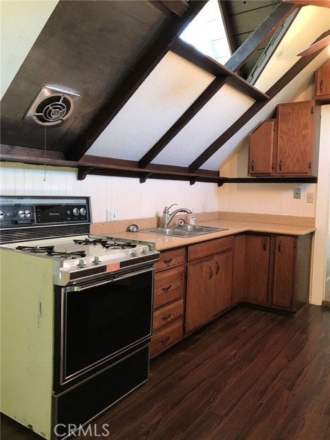 Cooking side of kitchen.  Notice open ceiling panel to let in natural light from gable.