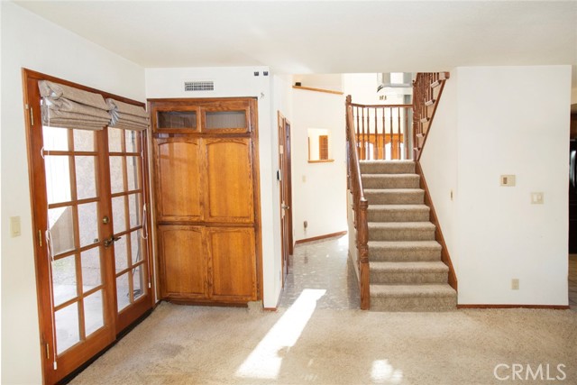 Family Room: Fireplace, storage and French Doors to side patio