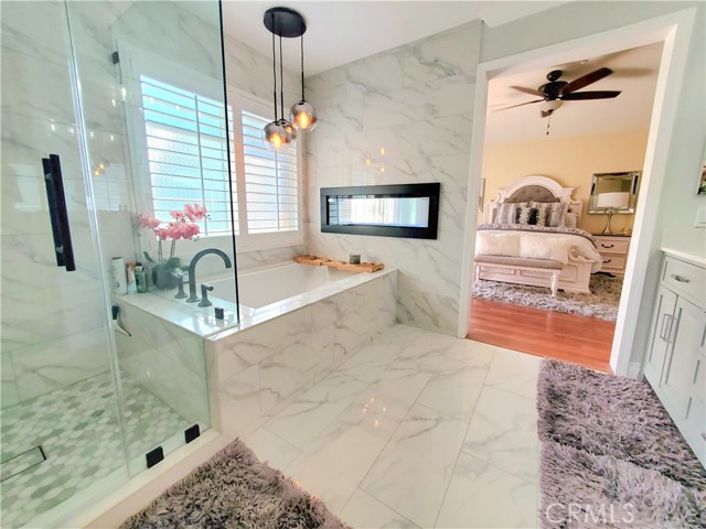 Master suite with fully renovated bathroom with porcelain floors and soaking tub and fireplace.