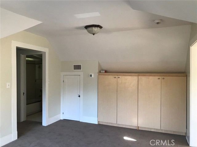 Room in middle of attic where entry is.  Door at left leads to short hall with full bath and kitchen.