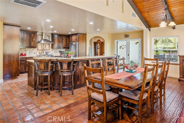 Between the living room and kitchen is the dining area and it's flanked by 2 chandeliers.