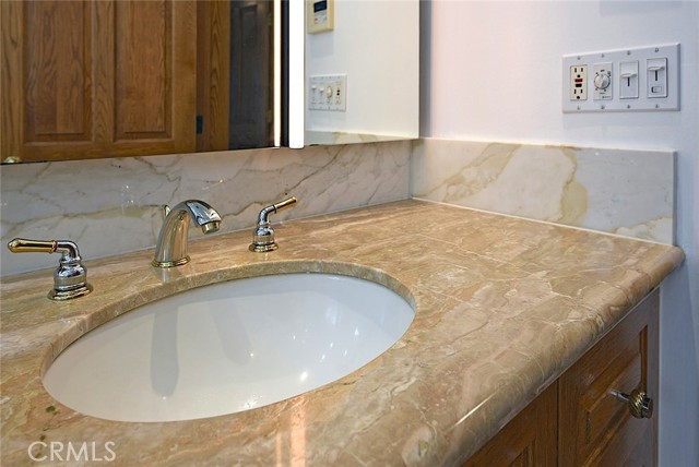 GFI-protected outlet; Panasonic exhaust-fan switch; dimmable Robern cabinet lights; dimmable ceiling lights; tankless water-heater control (see reflection in mirror, top center)