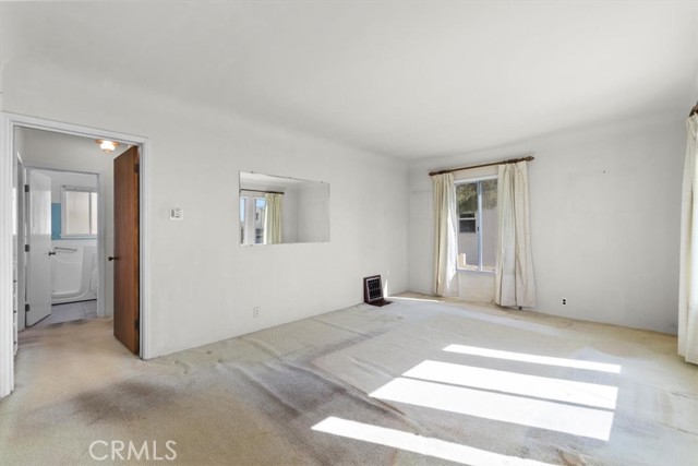 Front living/family room gets tons of southern light, there is hardwood underneath the carpet