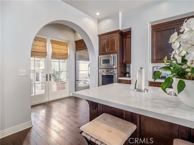 Dramatic archway leading from the gourmet kitchen to the private courtyard