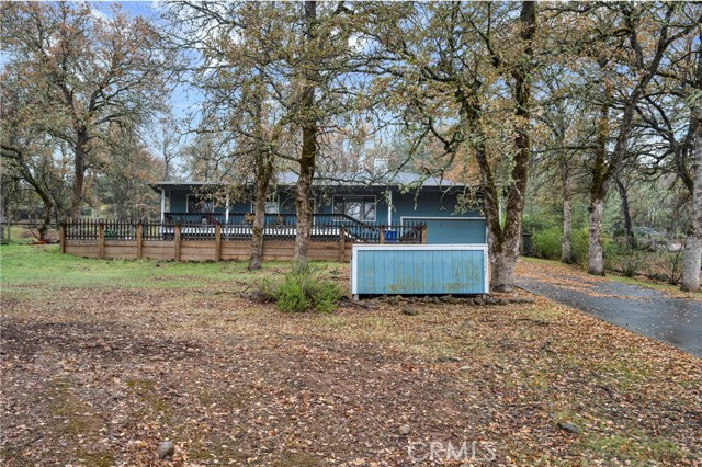 Seclusion on Siesta! Set amongst the Oak trees on a quiet cul-de-sac near Hidden Valley Lake's Equestrian Center, over 1/2 acre of fenced property with long driveway & plentiful parking. The 1,784 sq/ft home has 3 bedrooms & 2 bathrooms, a nice open floor plan with vaulted ceilings & new light fixtures throughout. The home has been recently updated with attractive laminate flooring. Living room includes a wood burning stove on a stone hearth & nice ceiling fan. Kitchen with tile flooring, breakfast bar & painted cabinetry. Indoor laundry with storage off of the dining area for your convenience! Sliding glass doors lead to the oversized, naturally landscaped backyard. Plenty of room for entertaining guests or allowing kids & pets to enjoy the fresh Lake County air. Newer roof, gutters & heat pump are an added bonus! Leased Solar with low monthly payments for energy efficiency! Large primary bedroom with walk-in closet & newer ceiling fan. Updated primary Bath with tile flooring, large walk-in tile shower and newer vanity for that spa like feeling in your very own home! Located in the gated community of Hidden Valley Lake, enjoy the 18 hole golf course, 102 acre lake, tennis courts, equestrian center, parks and more!