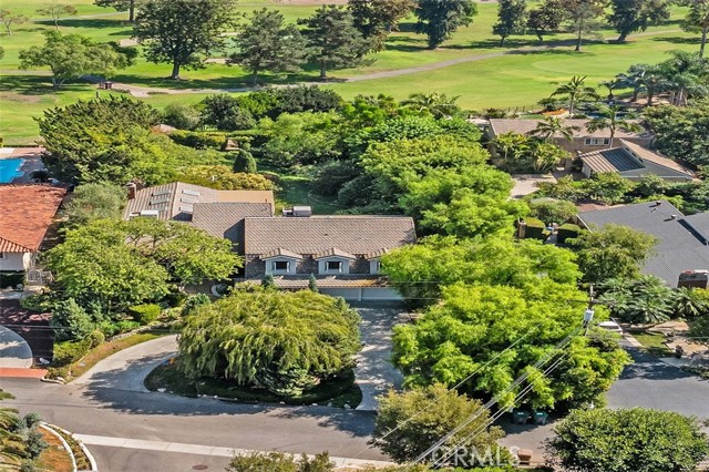 Welcome to this magnificent Yorba Linda golf course estate, nestled on a beautifully landscaped nearly 27,000-square-foot lot, designed by the renowned Roger’s Gardens. This extraordinary property with plenty of privacy offers a perfect balance of luxury and functionality, with the rare zoning for horses, making it an ideal retreat for equestrian enthusiasts and those seeking refined living. Amenities include Viking stove and double ovens, Sub Zero side by side fridge, water purifier, whole house vacuum. As you enter through the custom front door, you’ll be greeted by a stunning interior that includes a private office with its own entrance—perfect for working from home in privacy—and an artist loft that inspires creativity. The spacious living areas are complemented by custom built-ins, several sky lights, and a custom-designed fireplace, adding warmth and elegance to the home. Garage has wall to wall cabinets,and large extra storage area that can be used as a workshop. The circular driveway not only enhances the home's curb appeal but also offers convenience and ample parking for guests. With plenty of room for an ADU (Accessory Dwelling Unit), and a pool, this property provides endless possibilities for expansion or creating additional living space for family or guests. Whether you’re enjoying the scenic golf course views, envisioning equestrian opportunities, or planning to expand the estate, this Yorba Linda gem is a unique opportunity to experience luxury living in a prime location.