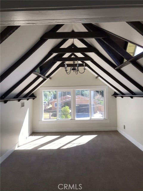 Front of unit facing street with beamed ceilings.